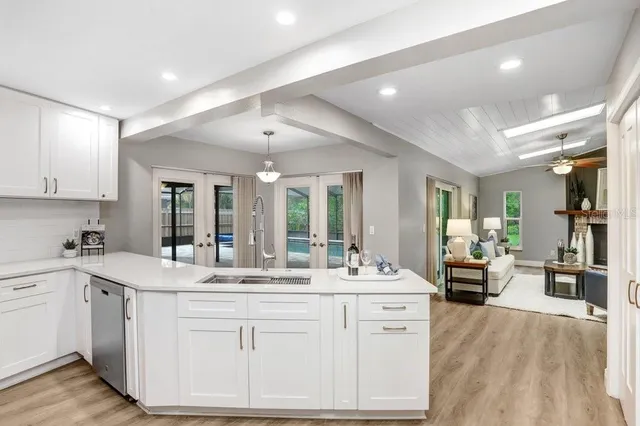 a large kitchen with kitchen island a sink stainless steel appliances and cabinets