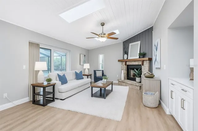 an empty room with a window and ceiling fan