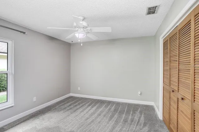 a bathroom with a granite countertop sink vanity and a mirror