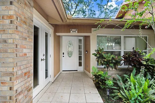 a view of a house with potted plants