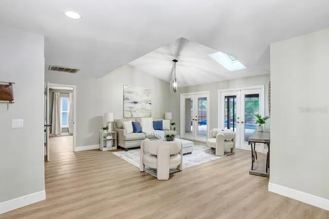 a living room with furniture and wooden floor