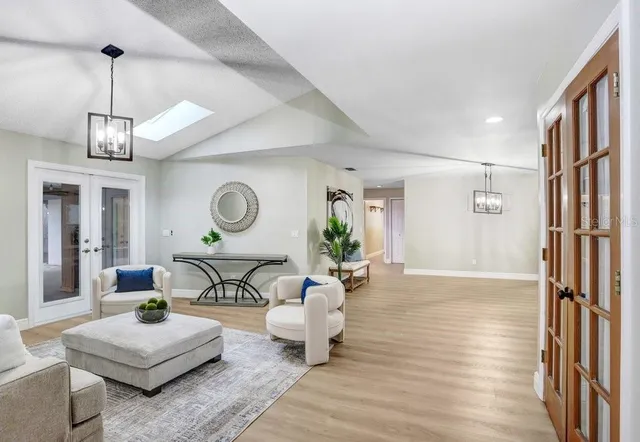 a living room with couch and a chandelier