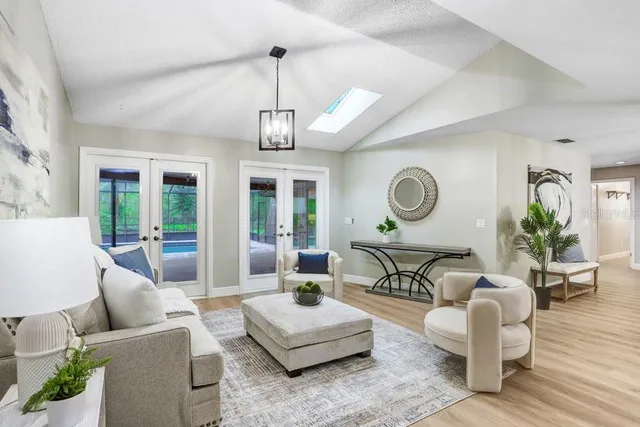 a living room with furniture and wooden floor