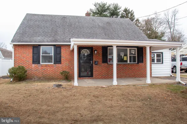 a house that has a tree in front of it