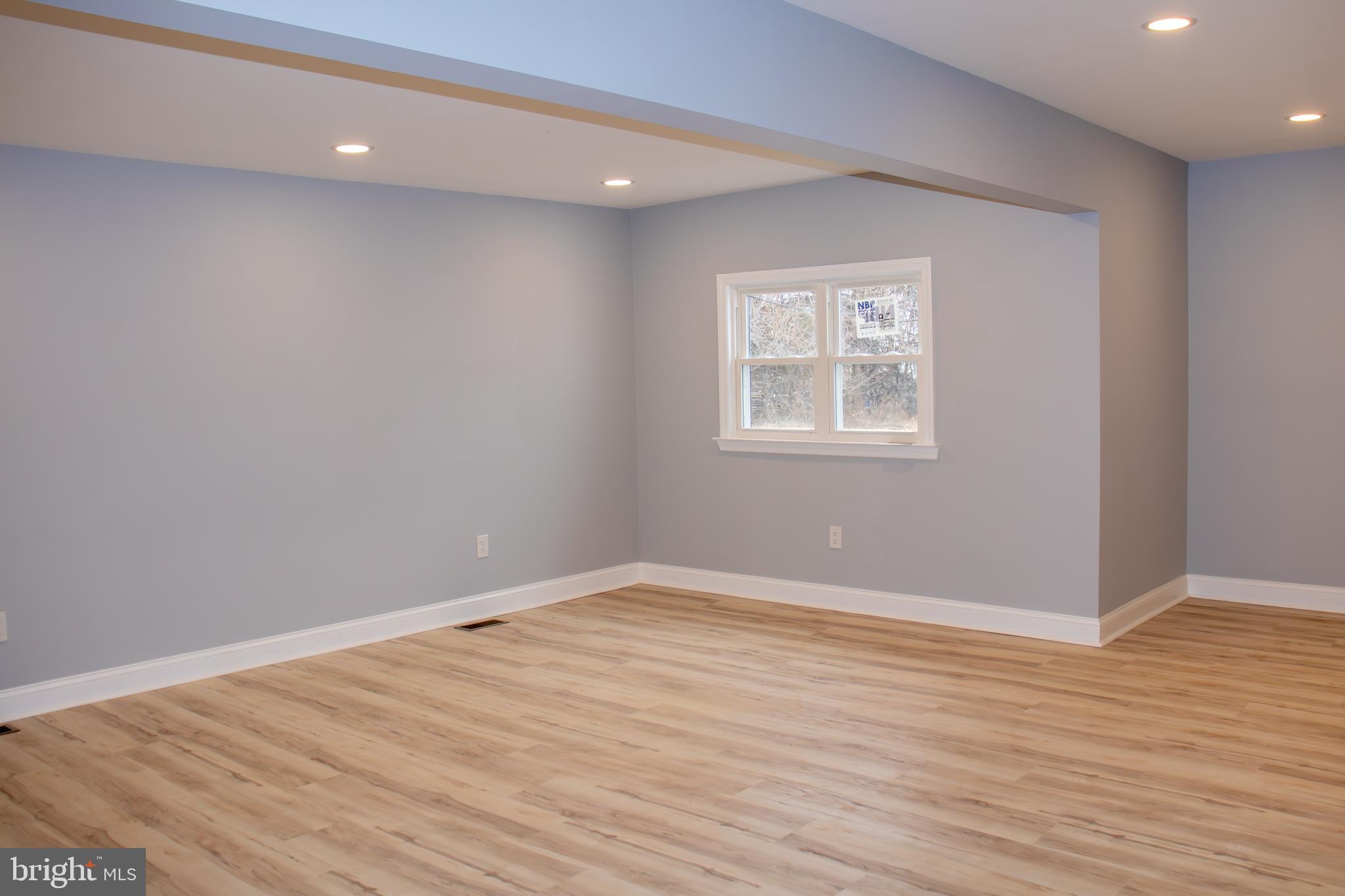 952 Columbus Road Burlington, NJ 08016 - Photo 14 of 36 an empty room with wooden floor and windows