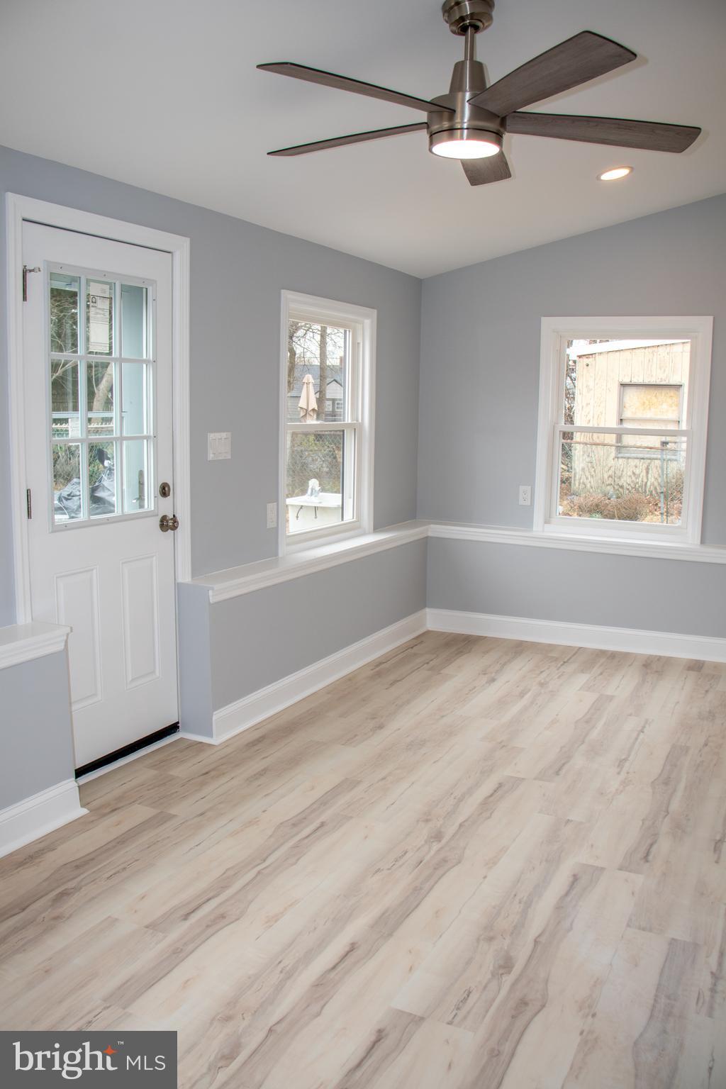 952 Columbus Road Burlington, NJ 08016 - Photo 19 of 36 an empty room with wooden floor fan and windows