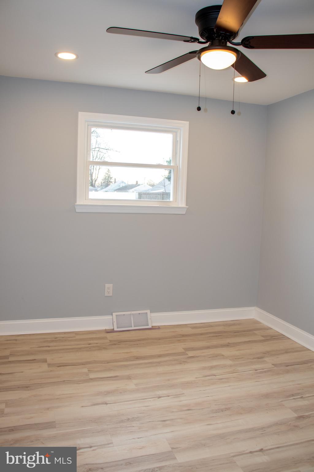 952 Columbus Road Burlington, NJ 08016 - Photo 24 of 36 a view of an empty room with wooden floor and a window