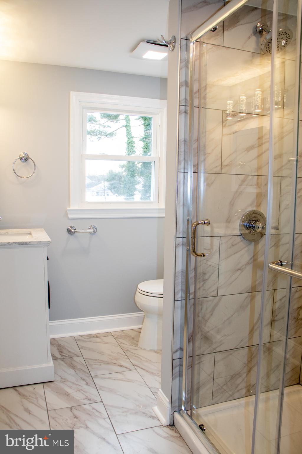 952 Columbus Road Burlington, NJ 08016 - Photo 33 of 36 a bathroom with a granite countertop toilet a sink and a shower