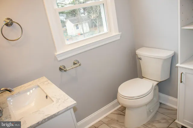 a white toilet sitting next to a bathroom sink