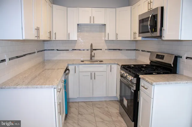 a kitchen with a sink stove and cabinets