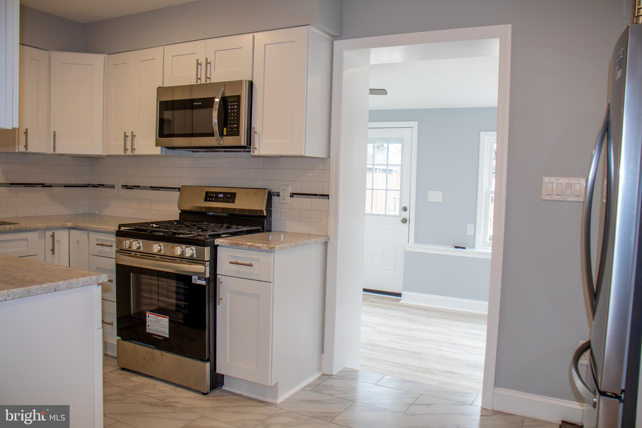 952 Columbus Road Burlington, NJ 08016 - Photo 7 of 36 a kitchen with stainless steel appliances a stove microwave and sink