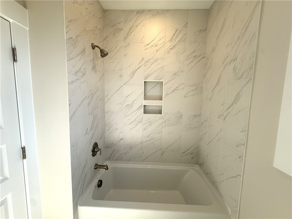 504 Tilman Court Anderson, SC 29621 - Photo 22 of 28 This bathroom features a sleek, tiled shower with a convenient built-in niche.