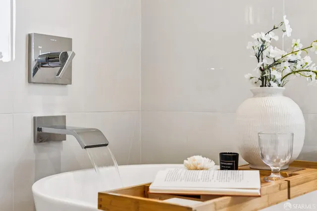 a view of a white house with a yard and potted plants