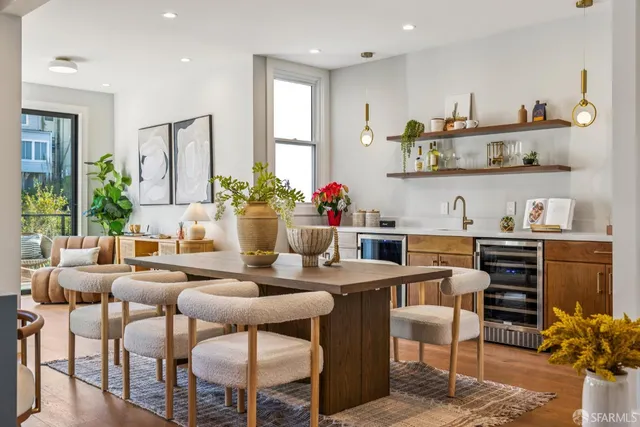 a dining room with furniture and a potted plant