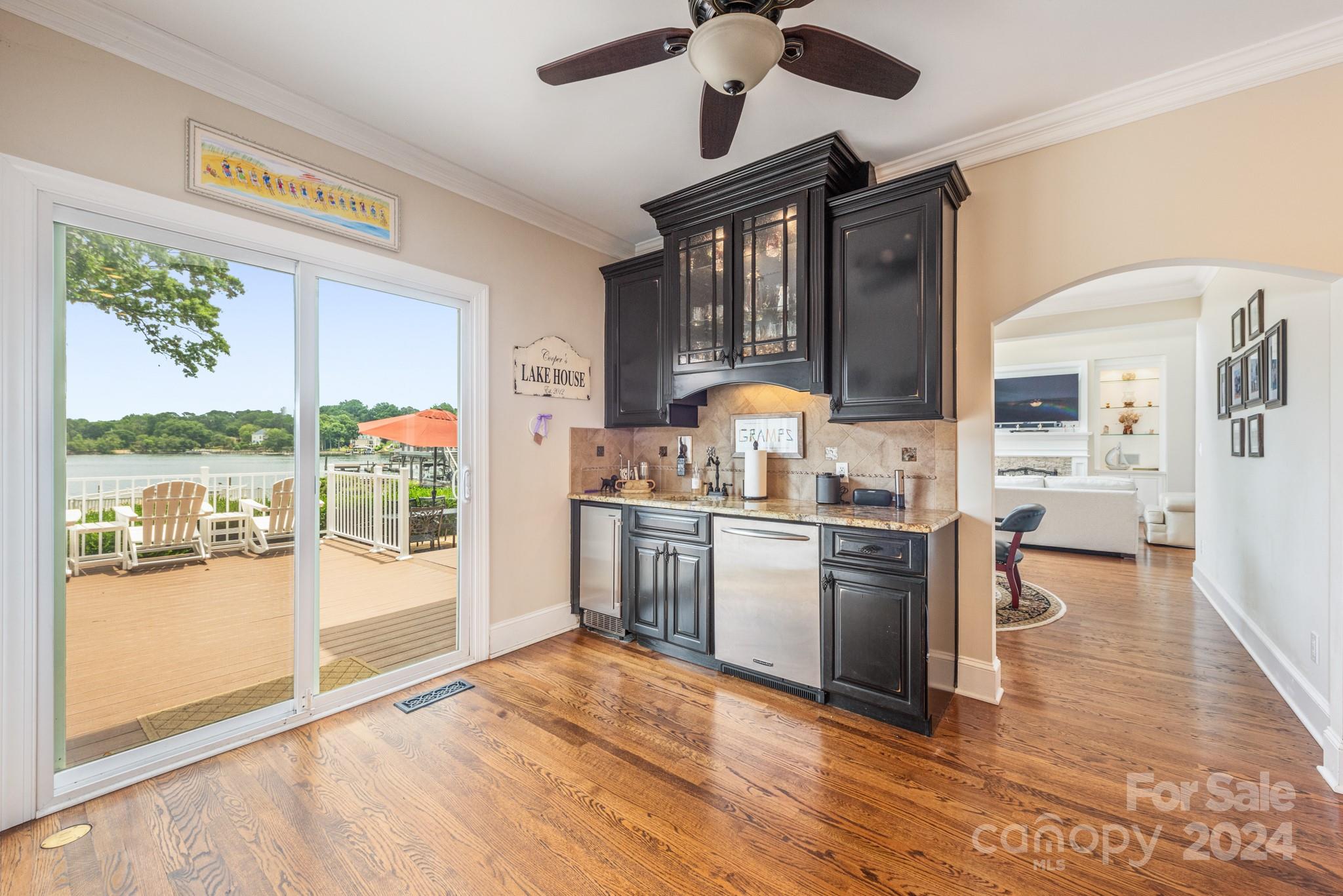 16711 Jetton Road Cornelius, NC 28031 - Photo 13 of 27 a kitchen with a stove a refrigerator and a fireplace with wooden floor