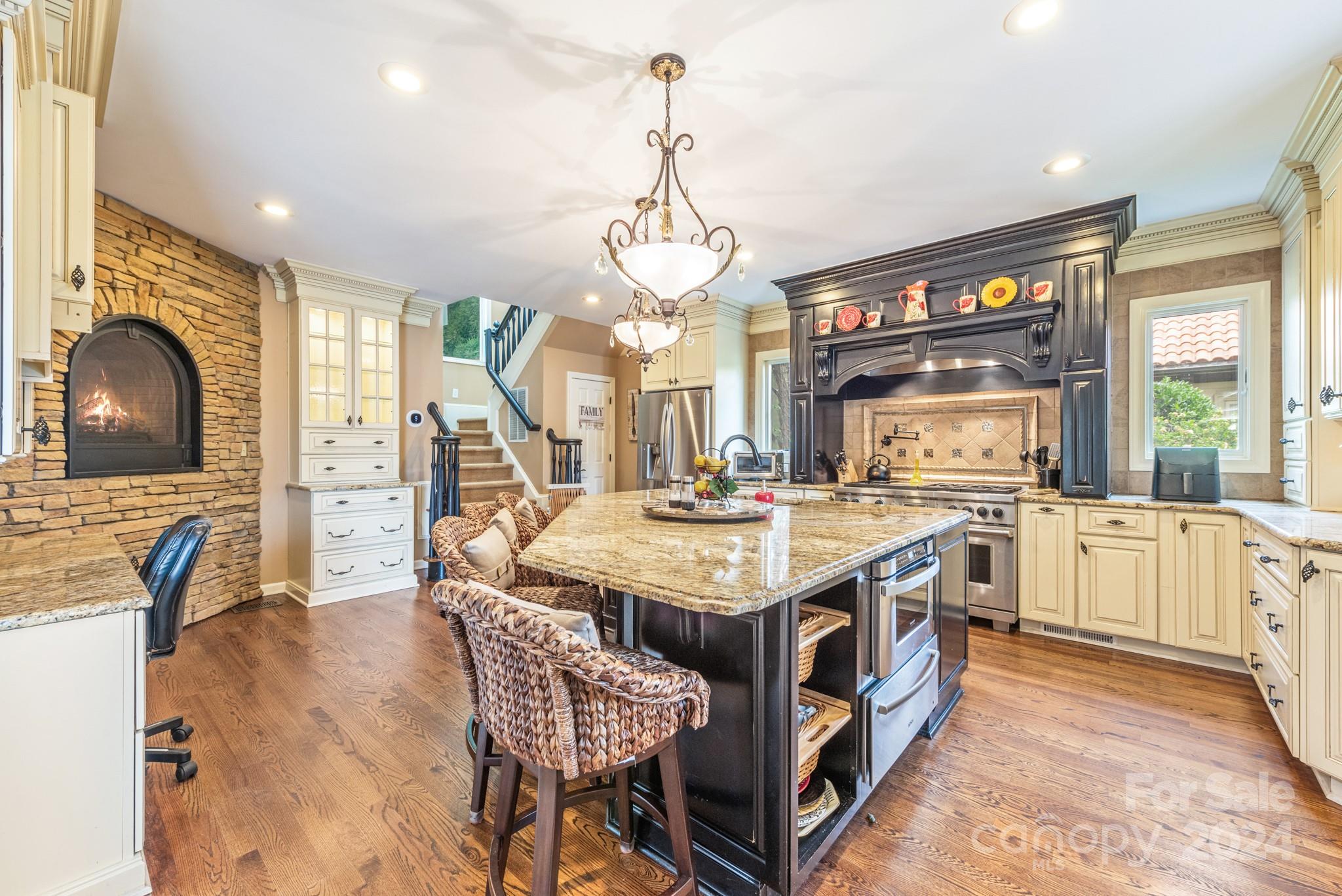 16711 Jetton Road Cornelius, NC 28031 - Photo 7 of 27 a kitchen with stainless steel appliances granite countertop a stove and a view of living room