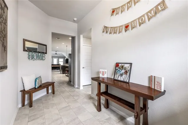 a large kitchen with stainless steel appliances a stove a sink a oven a dining table and chairs