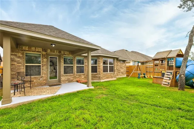 a view of a house with backyard porch and sitting area
