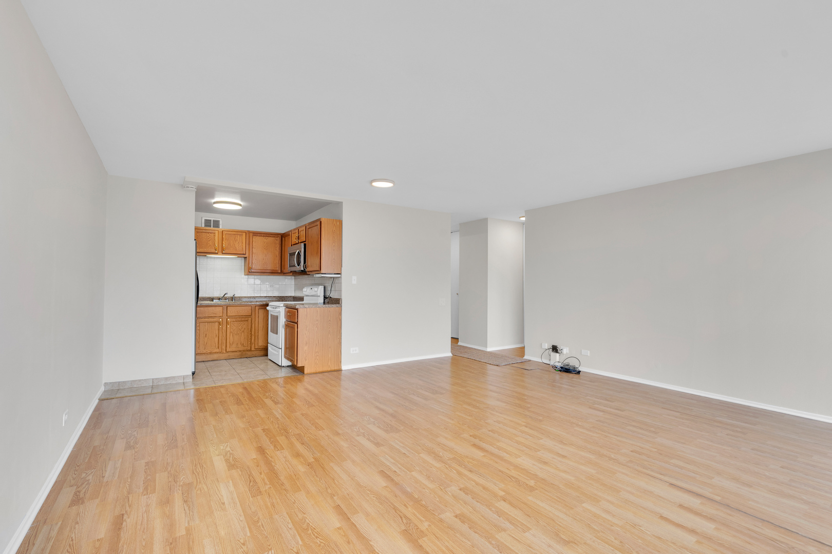 4343 North Clarendon Avenue, Unit 707 Chicago, IL 60613 - Photo 8 of 24 a view of a kitchen with wooden floor and a sink