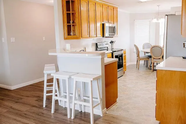 a dining room with furniture a chandelier and wooden floor