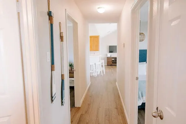 a bedroom with two beds and painting on the wall