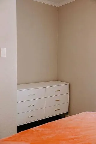 a bathroom with a bathtub a shower and a window