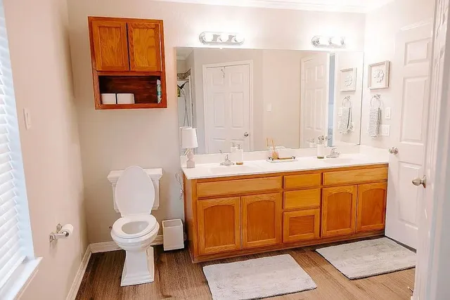 a bathroom with a sink a toilet and shower
