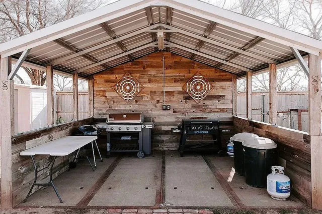 a view of a chairs and table in the back yard of the house