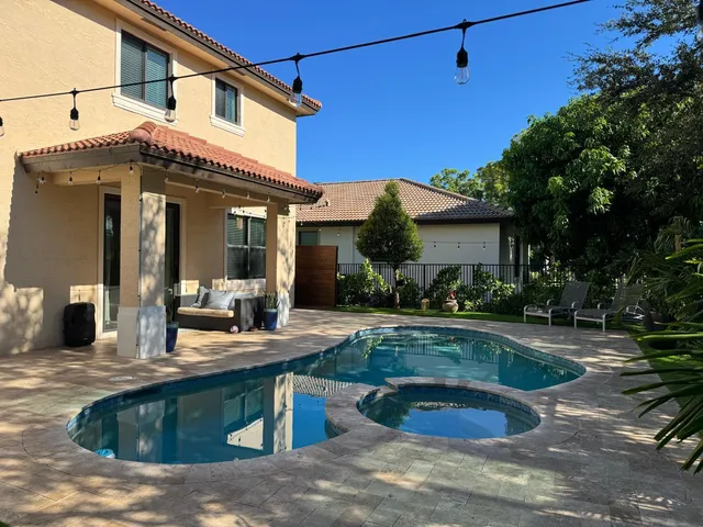 a view of a house with swimming pool patio and swimming pool