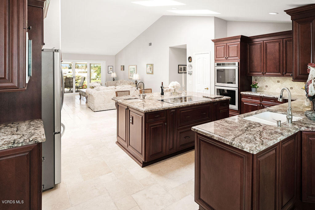 2607 Riata Court Camarillo, CA 93012 - Photo 13 of 54 a kitchen with kitchen island granite countertop wooden cabinets a sink and a stove