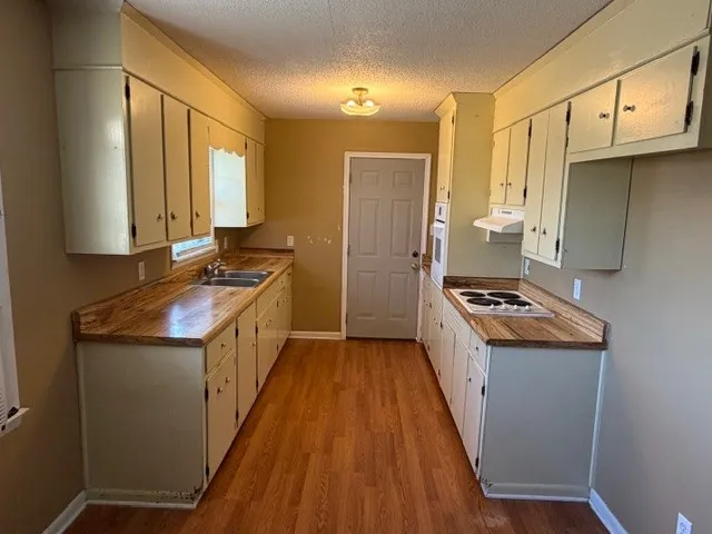 a kitchen with a stove a sink and a refrigerator