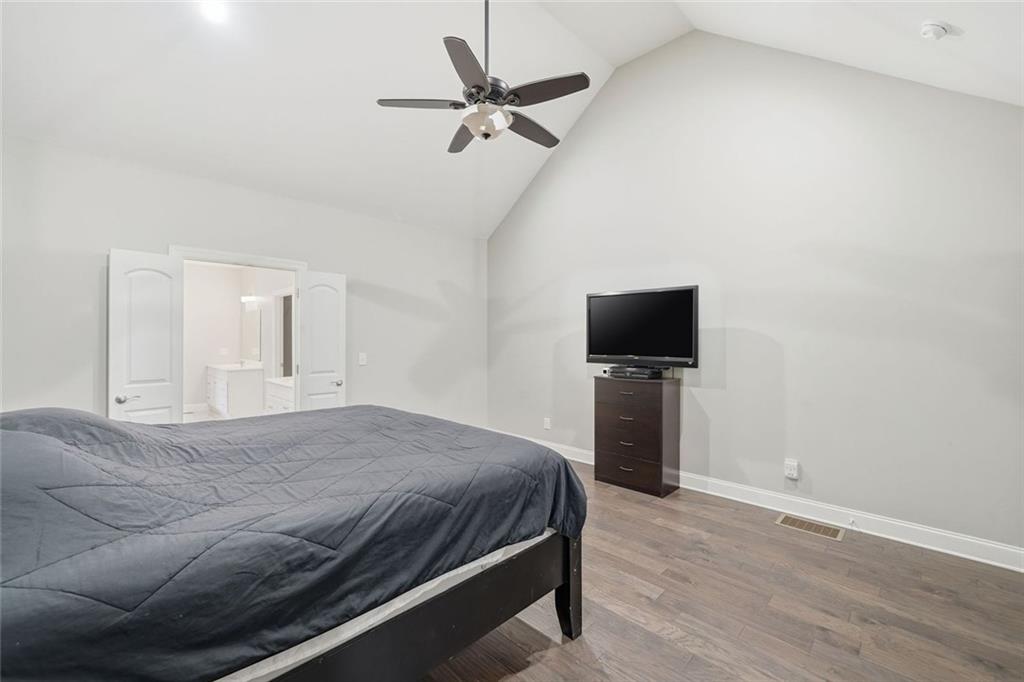 1006 Owens Store Road Canton, GA 30115 - Photo 21 of 48 a bedroom with a bed and a flat screen tv