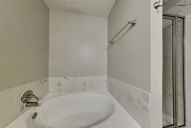 a bathroom with a tub and a sink