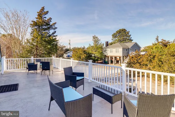a view of a roof deck with furniture