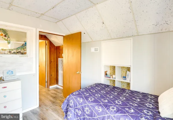 a bedroom with a bed and a dresser