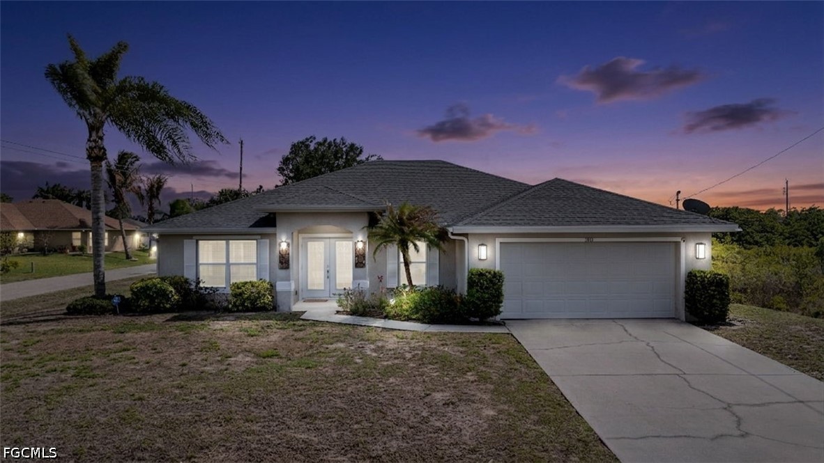 3801 28th Street Southwest Lehigh Acres, FL 33976 - Photo 2 of 37 a front view of a house with a yard and potted plants
