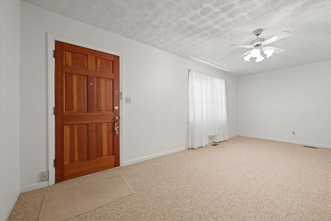 304 Shaw Road Honea Path, SC 29654 - Photo 12 of 39 This inviting entrance features a classic wooden door and comfortable carpeting, ready for your personal touch.