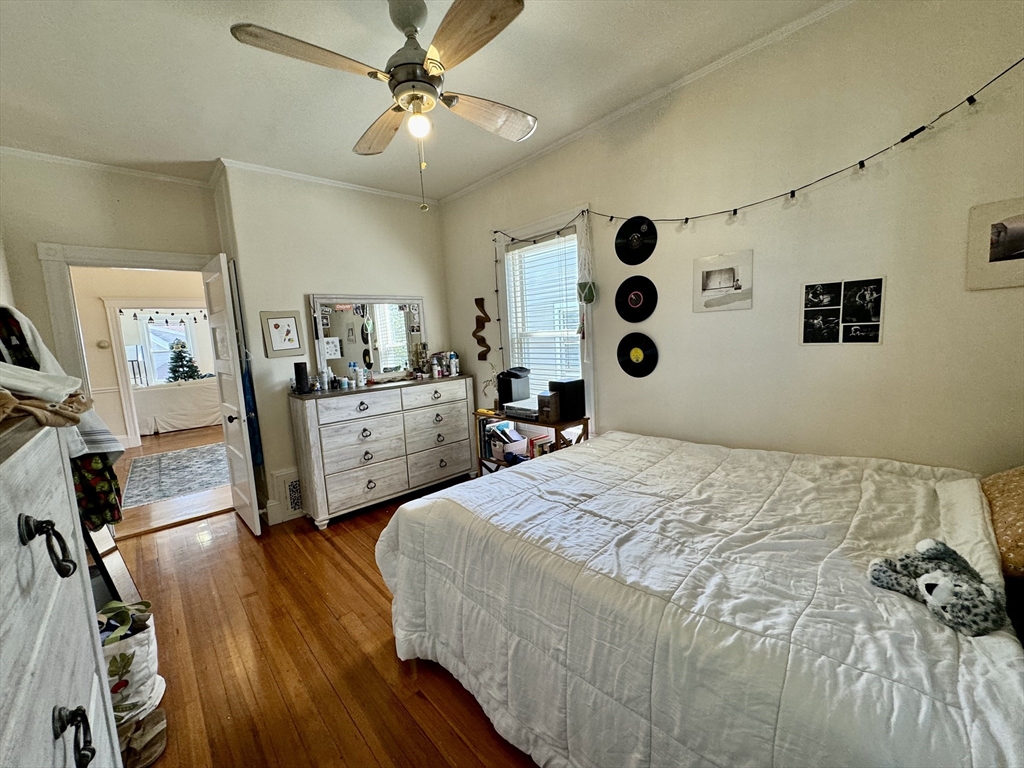 11 Wainwright Street, Unit 3 Boston, MA 02124 - Photo 11 of 26 a bedroom with a bed and a chandelier