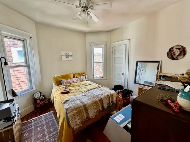 a bedroom with a bed and window