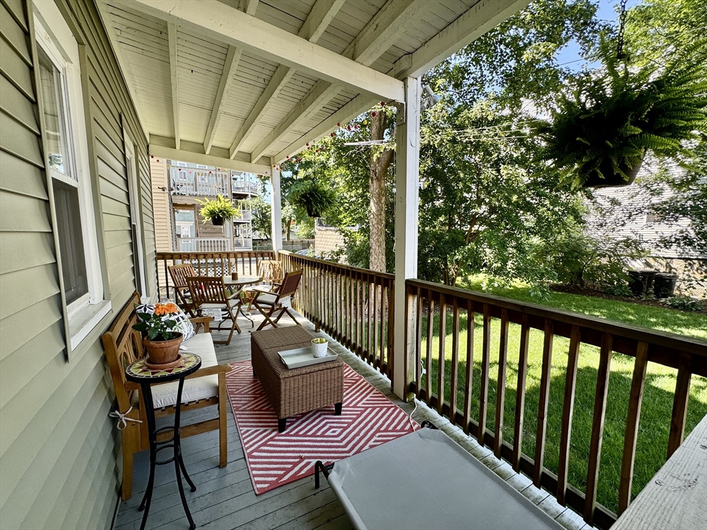 11 Wainwright Street, Unit 3 Boston, MA 02124 - Photo 17 of 26 a balcony with wooden floor and outdoor seating