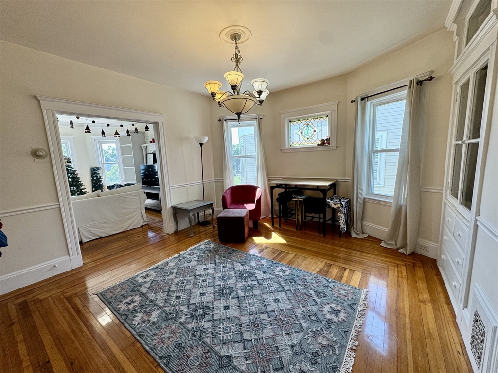 11 Wainwright Street, Unit 3 Boston, MA 02124 - Photo 2 of 26 a living room with furniture and a fireplace