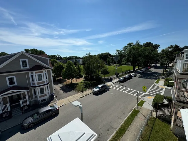 a view of multiple houses with city street