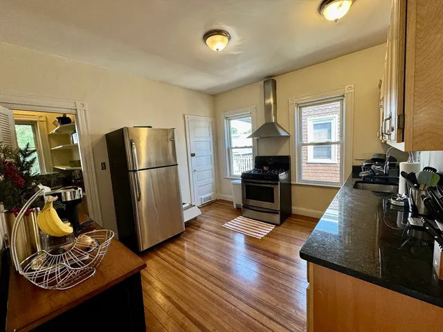 a living room with furniture fireplace and wooden floor