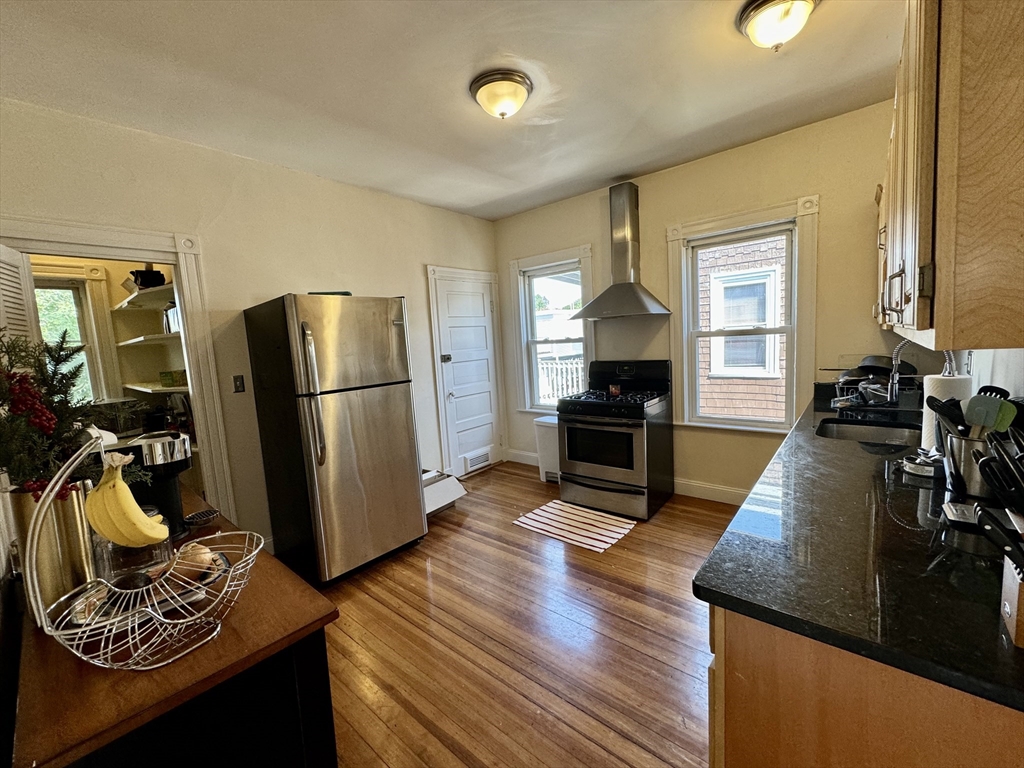 11 Wainwright Street, Unit 3 Boston, MA 02124 - Photo 4 of 26 a living room with furniture fireplace and wooden floor
