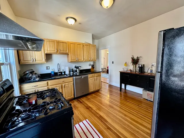 a kitchen with a sink and wooden cabinets