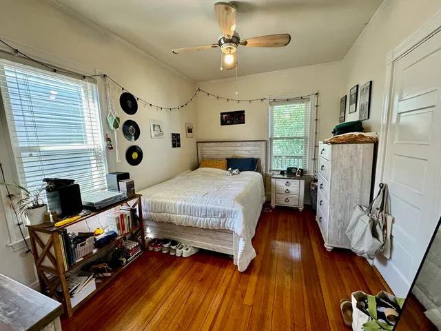 a bedroom with a bed and a flat tv screen on the dresser