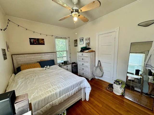 a bedroom with a bed dresser and a window