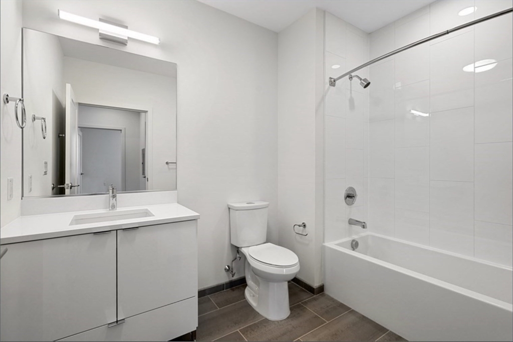 45 Lewis Street, Unit 312 Boston, MA 02128 - Photo 10 of 17 a bathroom with a sink toilet vanity and shower