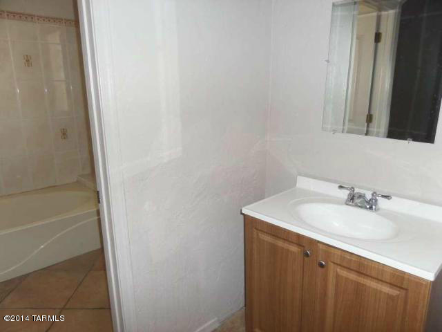 920 Paseo Queretaro Rio Rico, AZ 85648 - Photo 8 of 11 a bathroom with a sink and a mirror