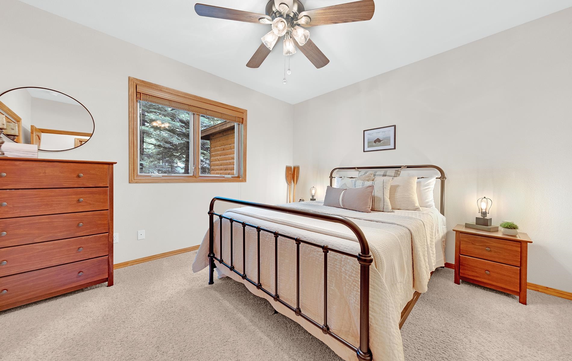 627 Deep Forest Road Lake Almanor, CA 96137 - Photo 19 of 29 a bedroom with a bed and a chandelier